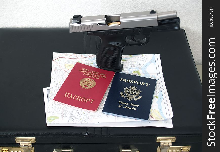Gun and two passports with map and case for russian spy