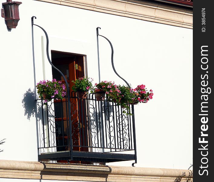 Small balcony with geranium on white background. Small balcony with geranium on white background.