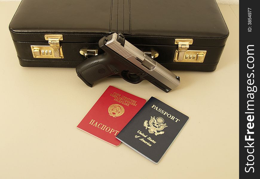 Two passports and gun with suitcase for special agent. Two passports and gun with suitcase for special agent