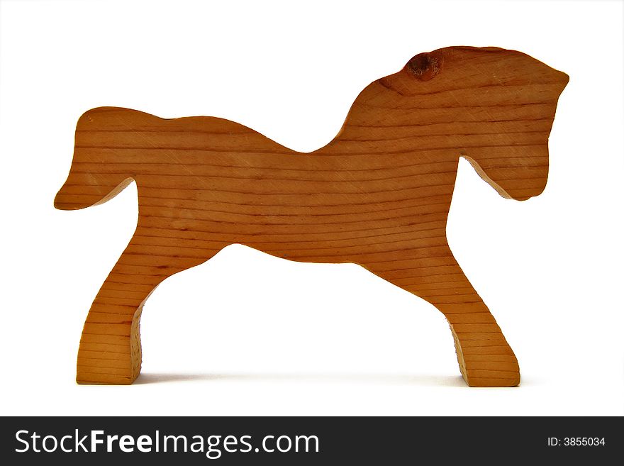 Horse carved from a block of wood, isolated on white. Horse carved from a block of wood, isolated on white