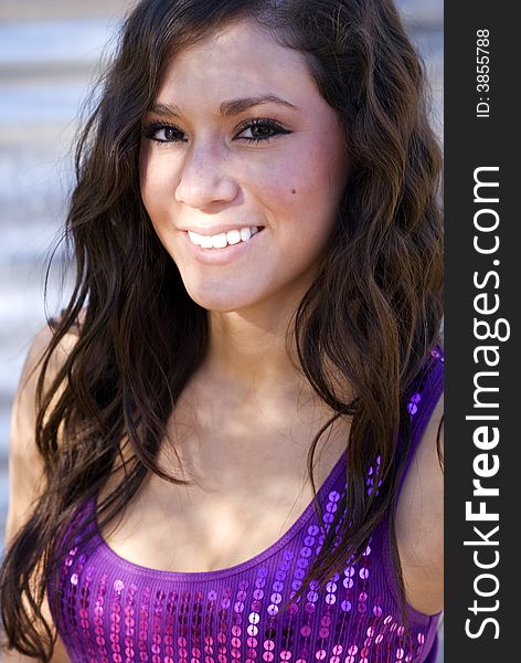 Beautiful woman smiling in purple sequined top. Beautiful woman smiling in purple sequined top