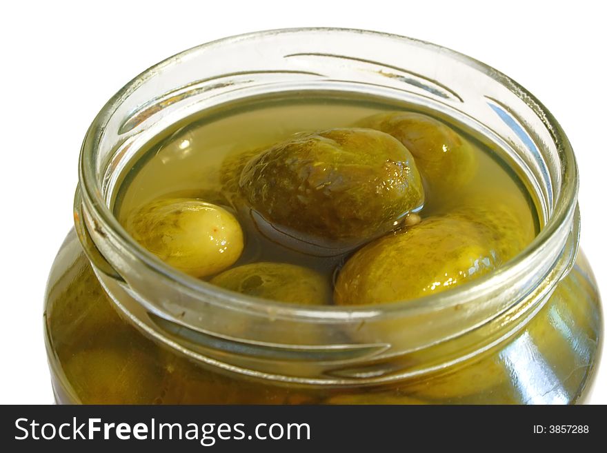 Pickled Cucumbers conserved in a glass on bright background