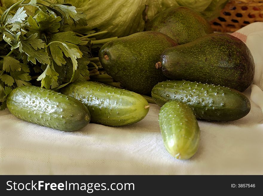 Washed vegetables.Cucumbers, avocado, salad, parsley.