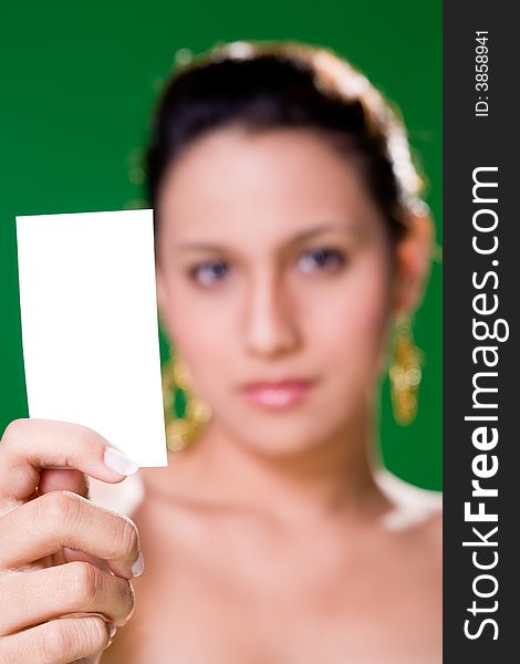 Beautiful girl holding white card on green background. Beautiful girl holding white card on green background