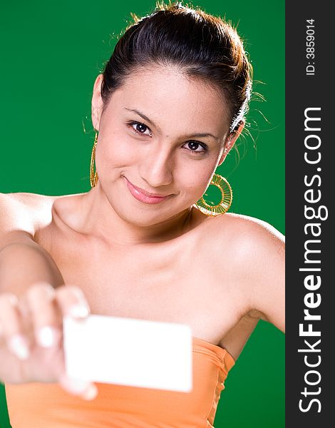 Beautiful girl holding white card on green background. Beautiful girl holding white card on green background