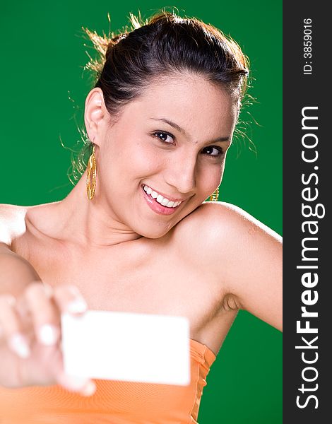 Beautiful girl holding white card on green background. Beautiful girl holding white card on green background