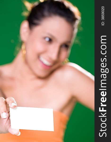 Beautiful girl holding white card on green background. Beautiful girl holding white card on green background