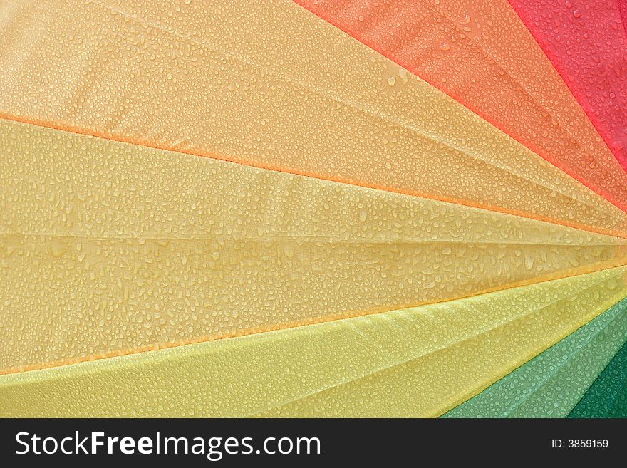 Close up from a wet colorful umbrella. Close up from a wet colorful umbrella.