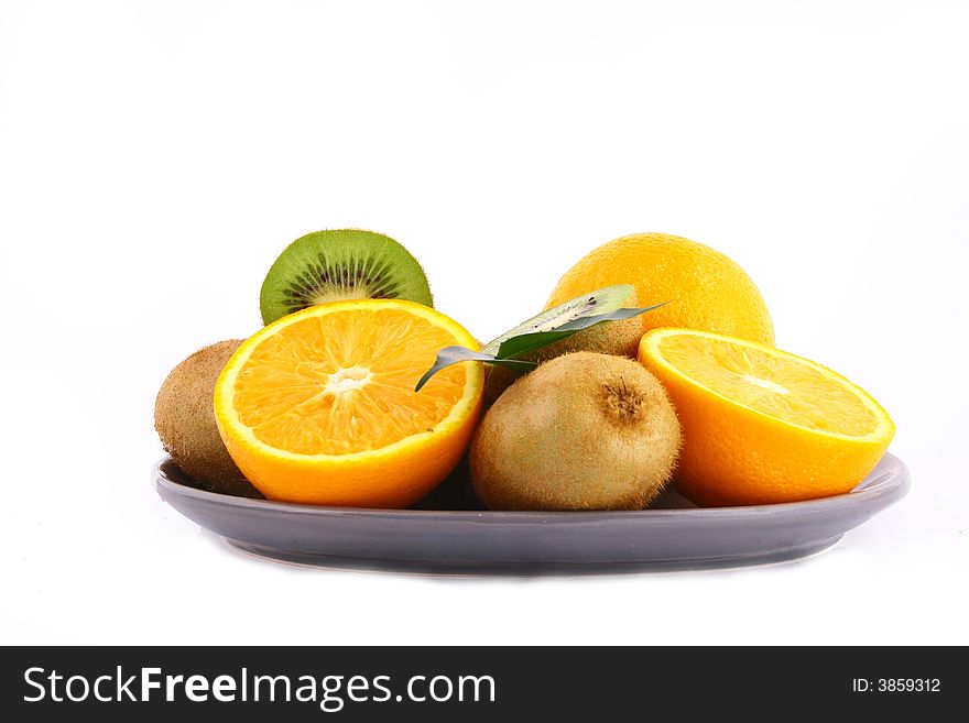 Kiwis and orange on white background