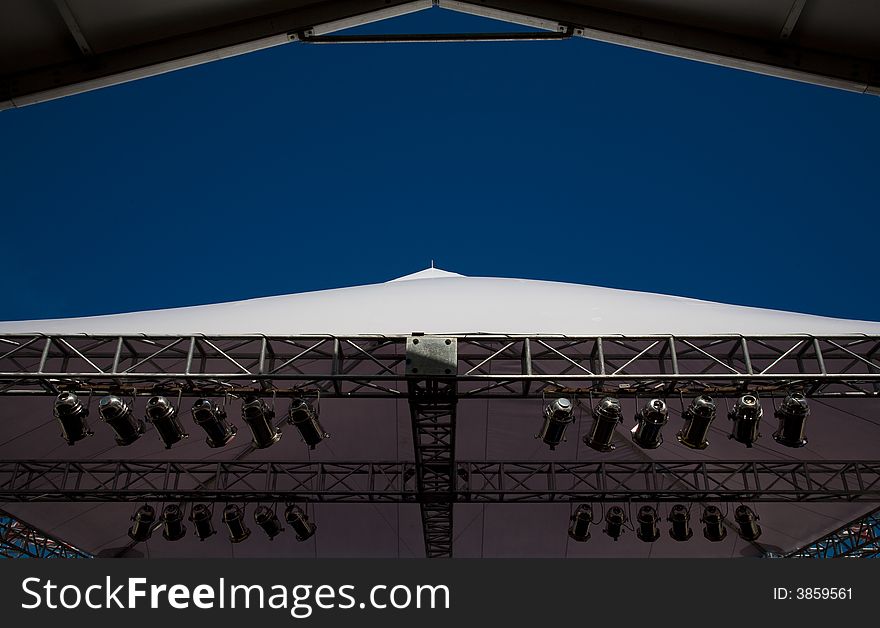 Stage lights and canopy on blue sky