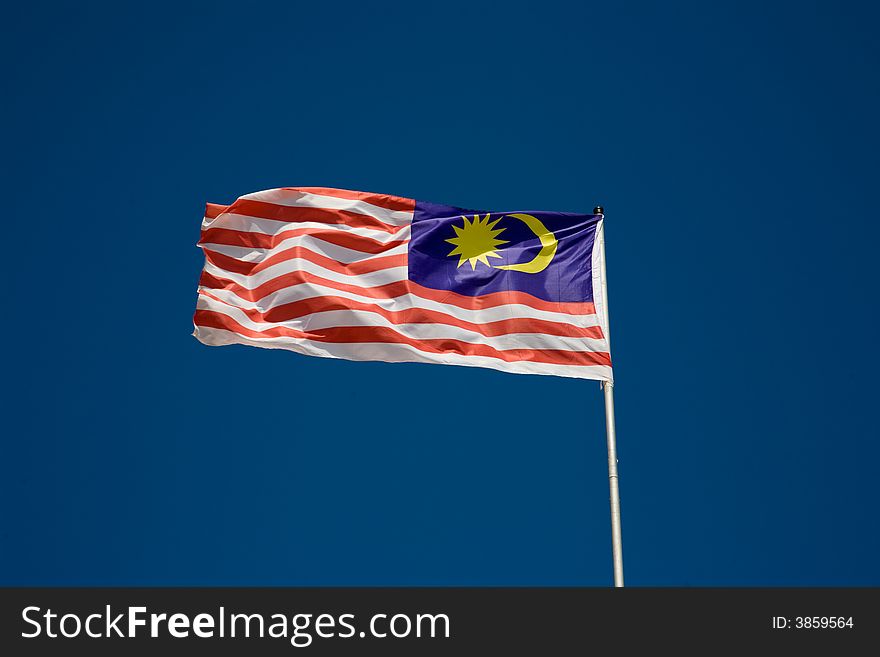 Wavy malaysian flag in blue sky