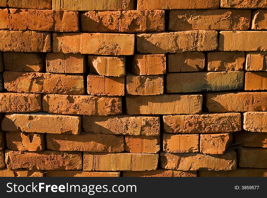 The wall of red burnt ruinous bricks. The wall of red burnt ruinous bricks
