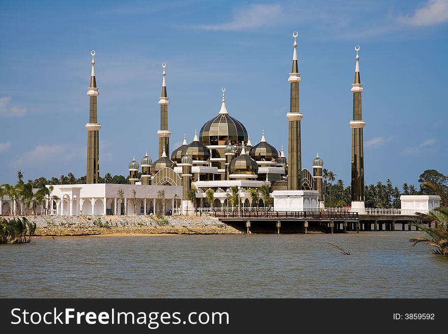 Floating crystal mosque by the river bank