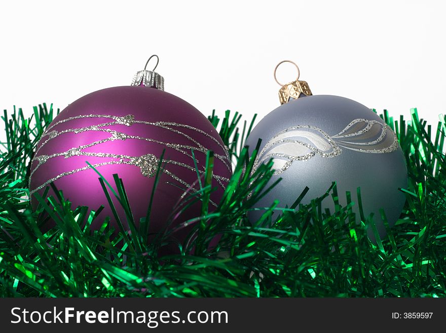 Two fur-tree toys on green garland and white background