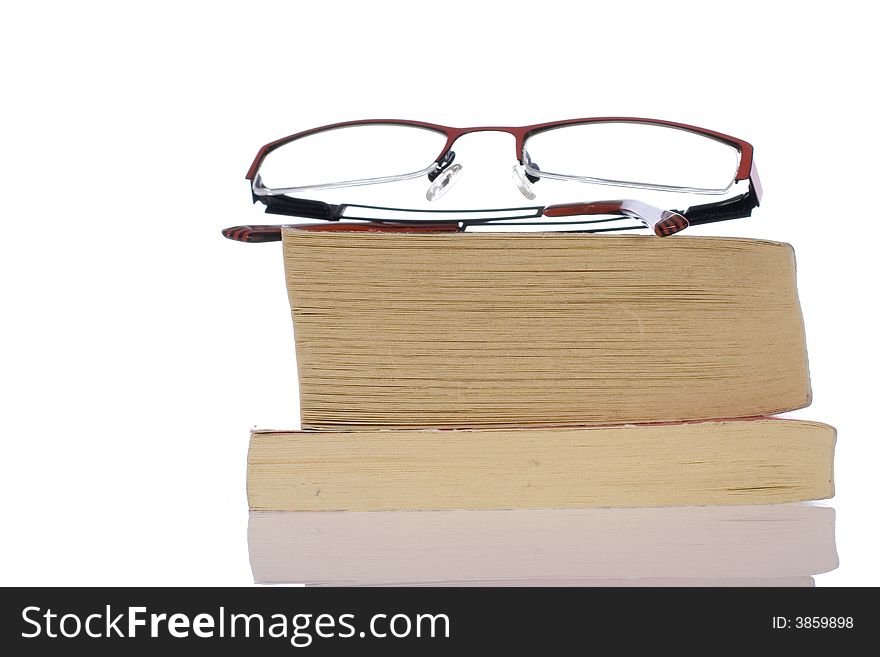 Glasses, specs, spectacles on pile of books