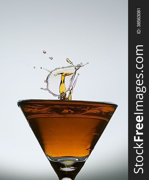 Splashing water drop on red glass.