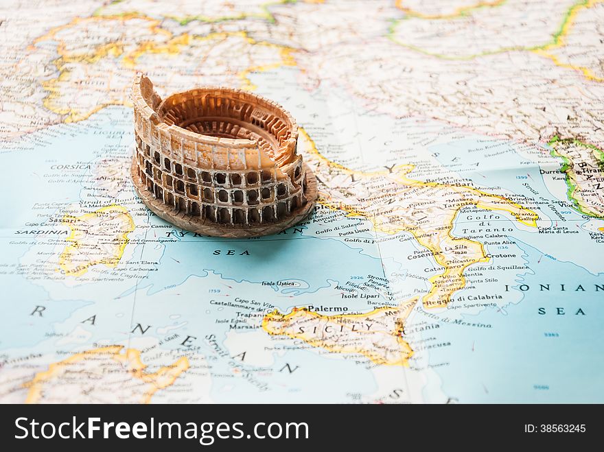 A Colosseum miniature on a map of Europe