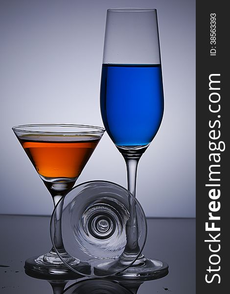 Three glasses on gray background.