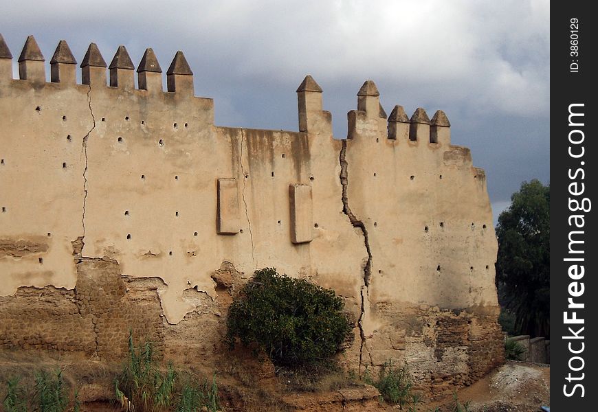 An old crack stone castle wall. An old crack stone castle wall.