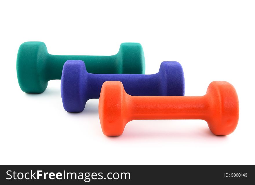 Three dumbbells of different colors of white background.