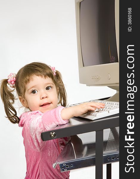 Cute little girl tuching keyboard. Cute little girl tuching keyboard