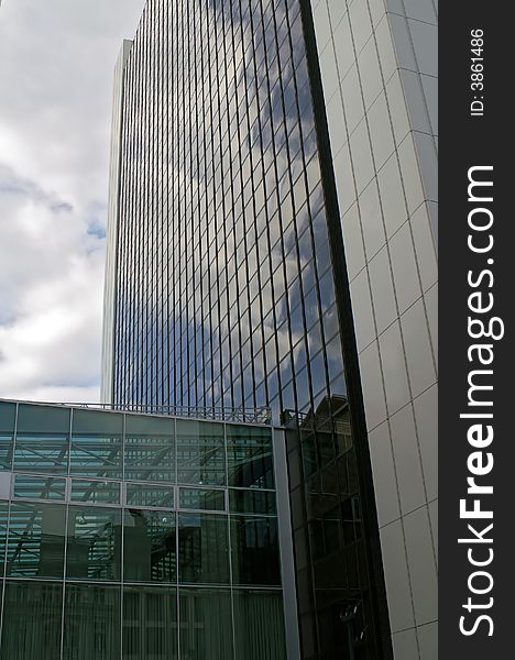 Berlin, glassy skyscraper and reverberating clouds. Berlin, glassy skyscraper and reverberating clouds