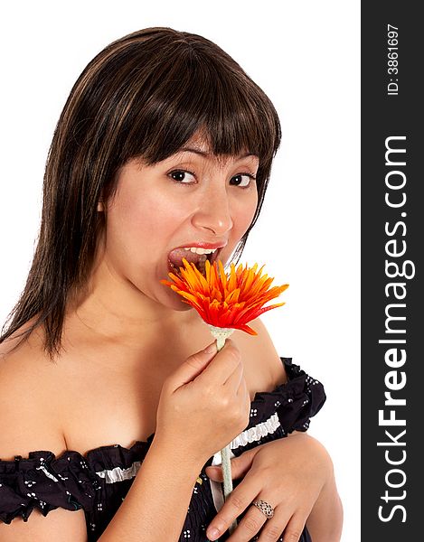 A young woman trying to eat a flower