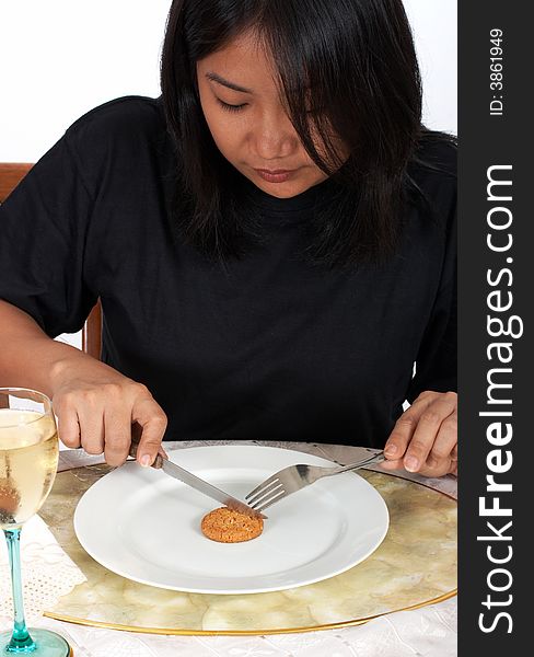 Woman holding fork and knife with cookies on plate. Woman holding fork and knife with cookies on plate
