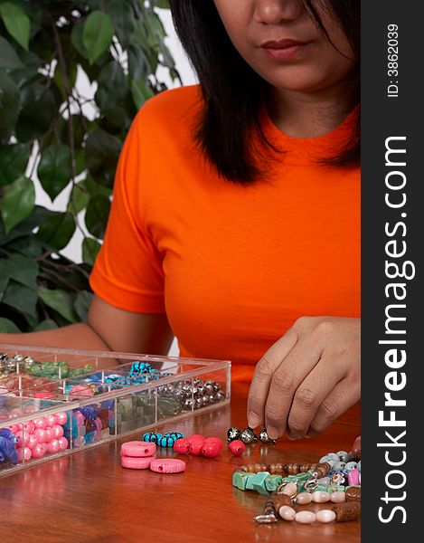 Woman holding beads in different colors. Woman holding beads in different colors