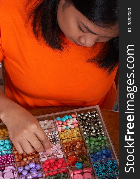 Woman holding beads with different colors. Woman holding beads with different colors