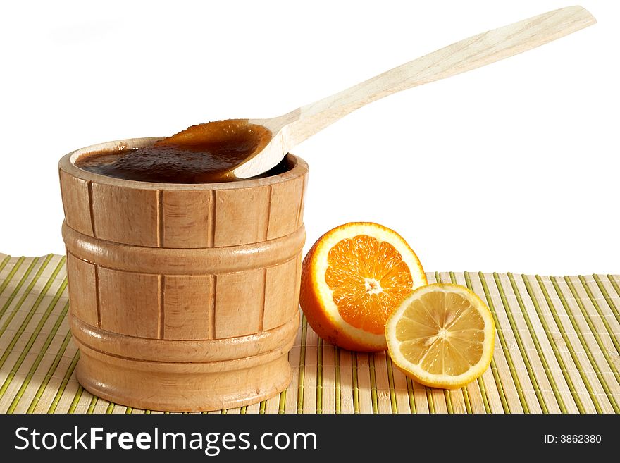 A pail with honey and slice of lemon. A pail with honey and slice of lemon