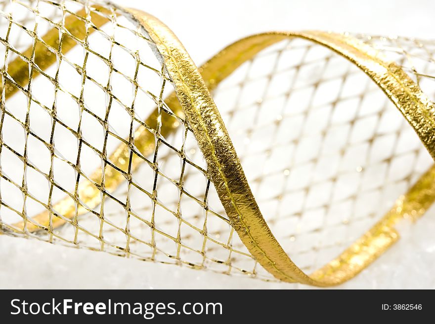 Golden Christmas ribbon on snow background