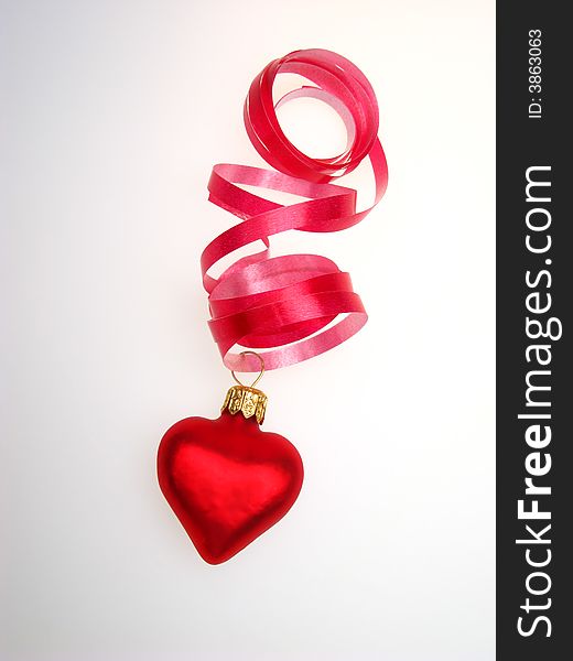 New Year's toy of red color as heart, on  white background