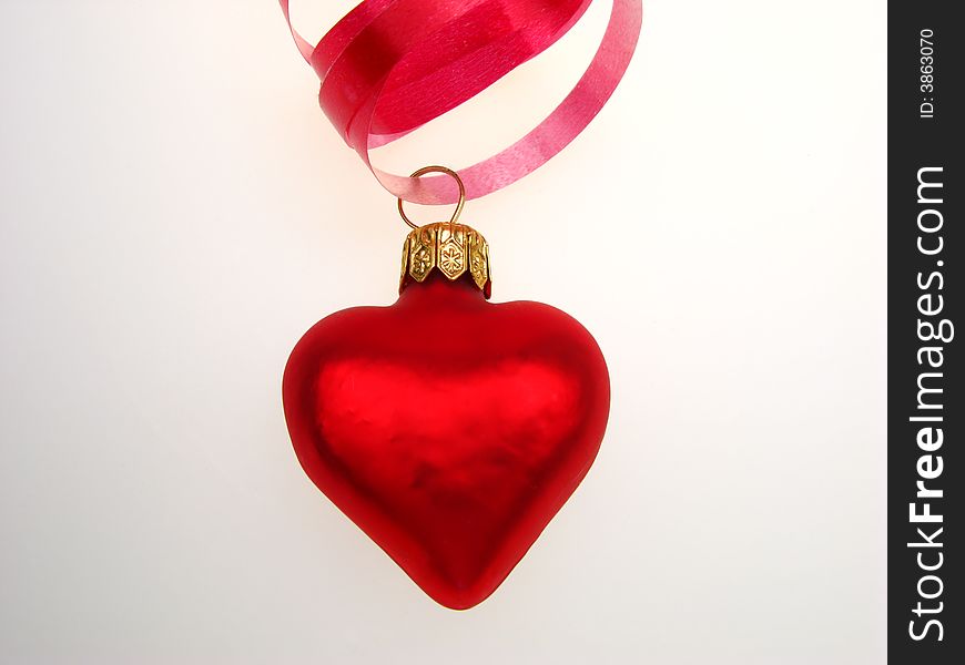 New Year's toy of red color as heart, on white background