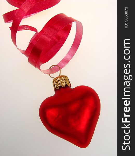 New Year's toy of red color as heart, on  white background