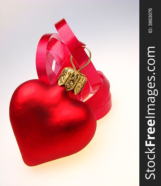 New Year's toy of red color as heart, on  white background