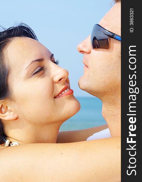 A portrait of attractive couple having fun on the beach. A portrait of attractive couple having fun on the beach