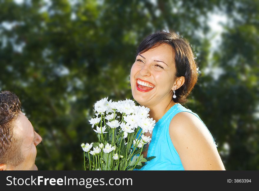 A portrait of attractive couple in summer environment. A portrait of attractive couple in summer environment