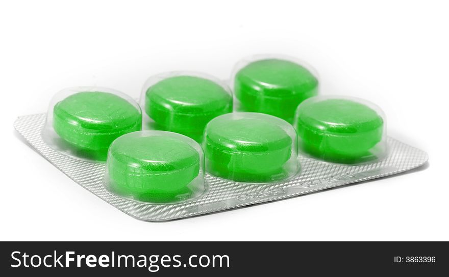 Green cough tablets in closeup on white background. Green cough tablets in closeup on white background