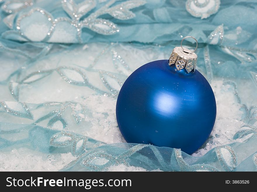 Blue Christmas ball on snow background