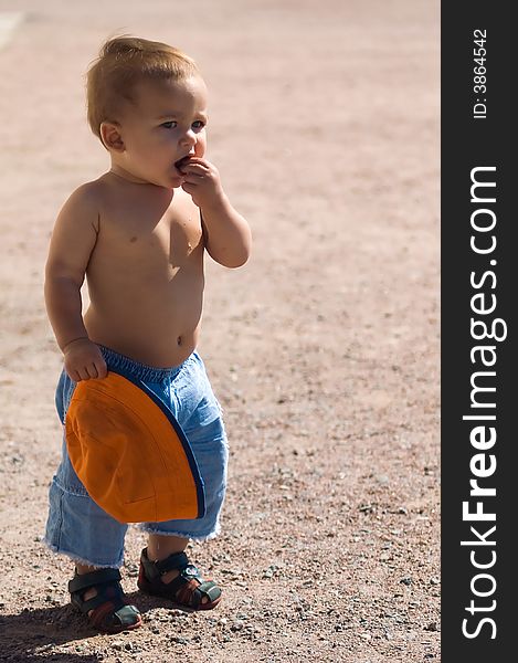 1 year baby eating something at sunny summer day. 1 year baby eating something at sunny summer day