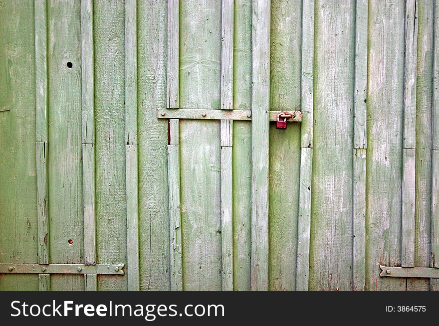 Padlock with old wooden background