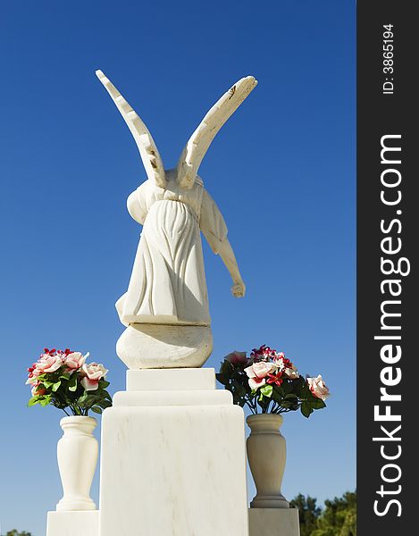 White angel sculpture in a catholic cemetery, Portugal