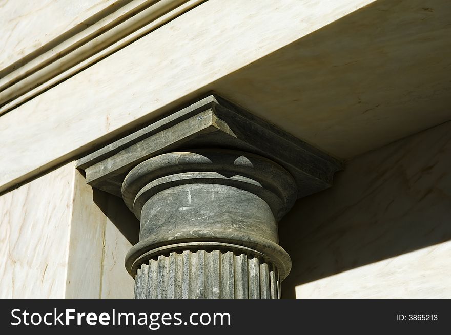 Building detail showing a black marble chapiter. Building detail showing a black marble chapiter