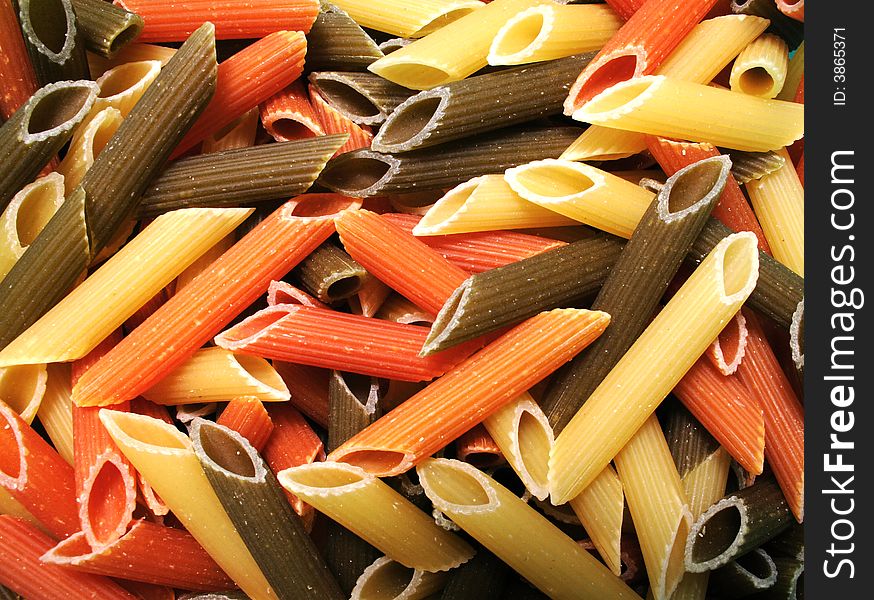 Uncooked tricolor noodle , kitchen background. Uncooked tricolor noodle , kitchen background