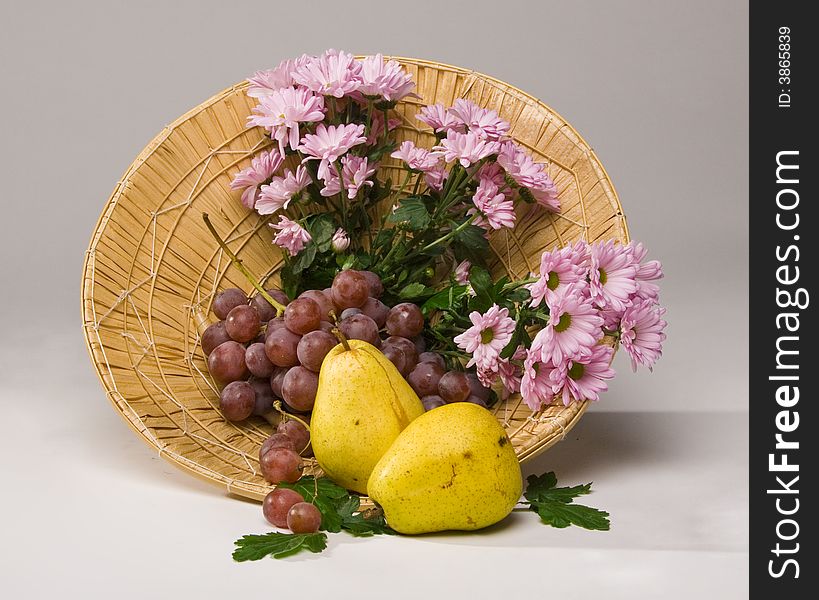 Basket with fruit and flowers. Basket with fruit and flowers