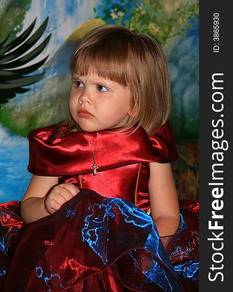 The girl in a beautiful velvet dress. A color background. The girl in a beautiful velvet dress. A color background
