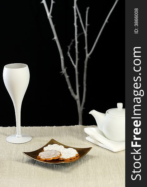 A modern table setting with cookies and tea