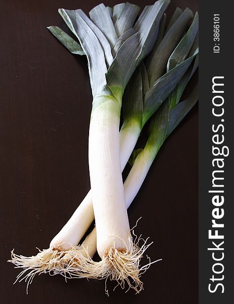 Three leeks on a black background