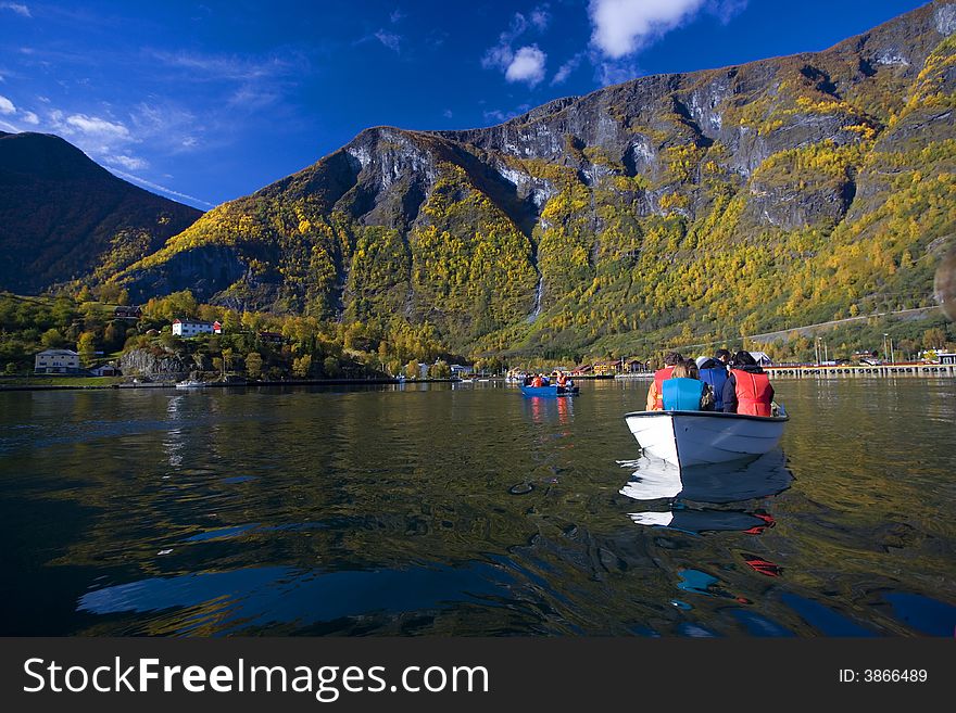 Autumn landscape with boats in the river